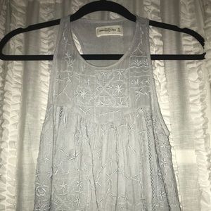 A grey, sheer tank top